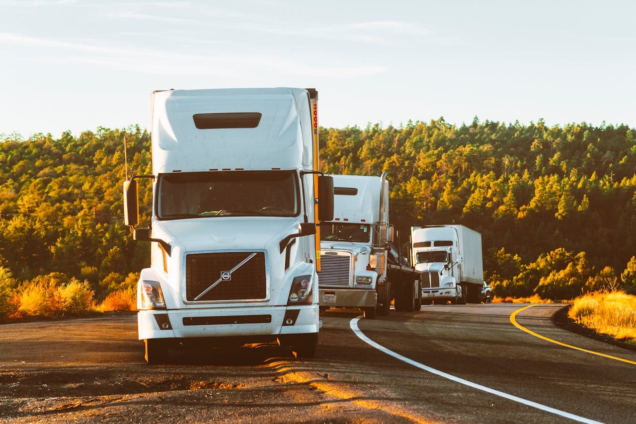 Trucks on highway at golden hour